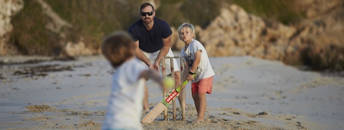 jindee dad sons playing beach cricket ocean jindalee land for sale